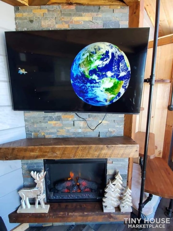 stone fireplace and mounted TV